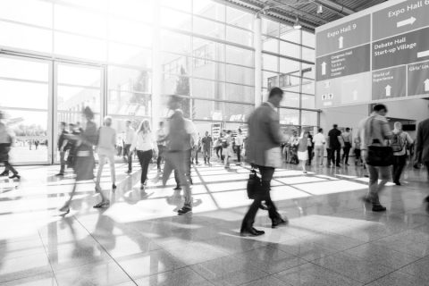 Black and white image of travelers in an airport.
