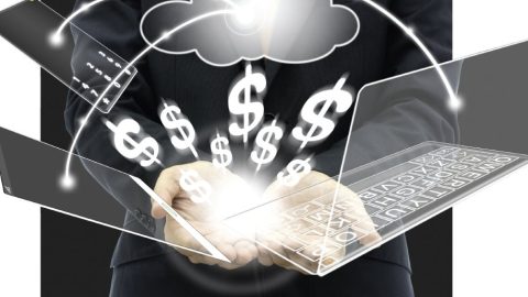 Graphic of electronics and dollar signs above a man's hands.