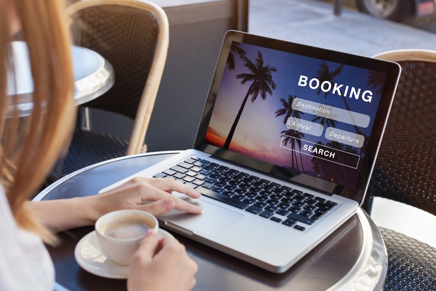 Woman on a laptop looking at booking site