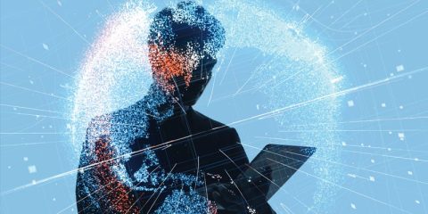 Silhouette of a person holding a tablet, surrounded by a glowing digital globe composed of data points, network lines, and light effects. The image represents global connectivity, digital communication, and data-driven technology.