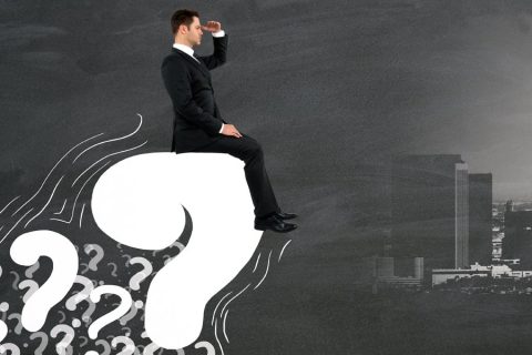 Man Sitting on Question Mark Looking Ahead