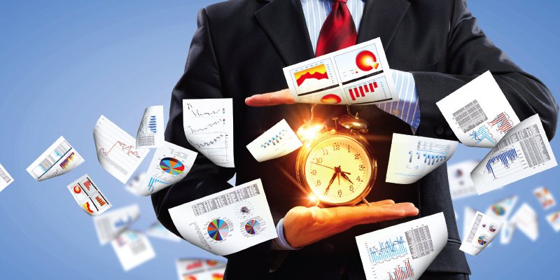 A business professional in a suit holding a glowing clock in their hands, surrounded by floating sheets of paper displaying charts, graphs, and data visualizations. The image symbolizes the management of time and data, highlighting efficiency, productivity, and data-driven decision-making in a corporate setting. The blue background enhances the dynamic, high-energy feel of the scene.