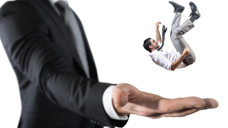 Mini man falling into a big man's hand.