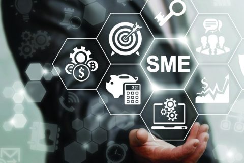 Hand holding holographic images related to SME.