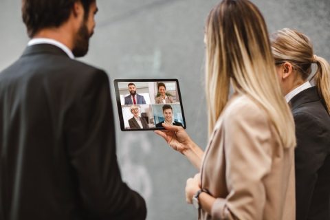 Business people videoconferencing on an ipad.